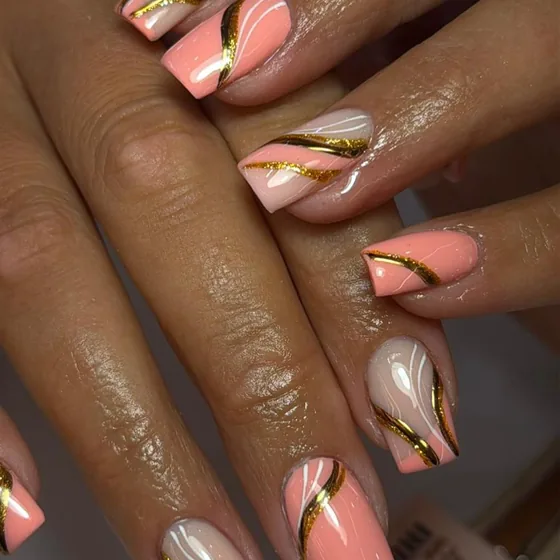 Pink and gold swirl nail art