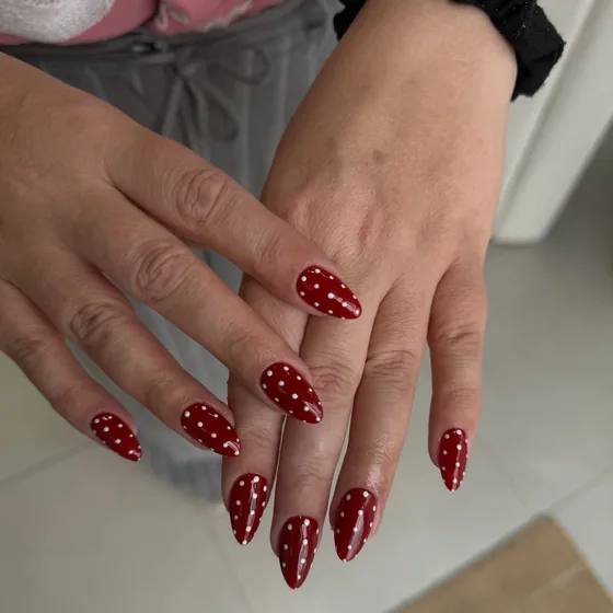Red nails with white polka dots
